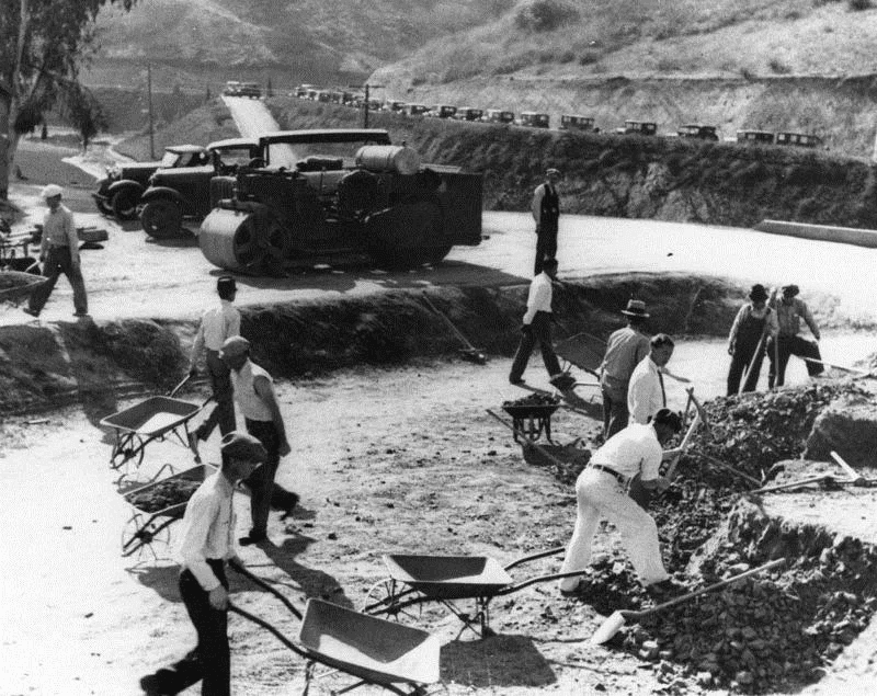 Black-and-white 1938 foundation dig with a Ford Model T and steamroller